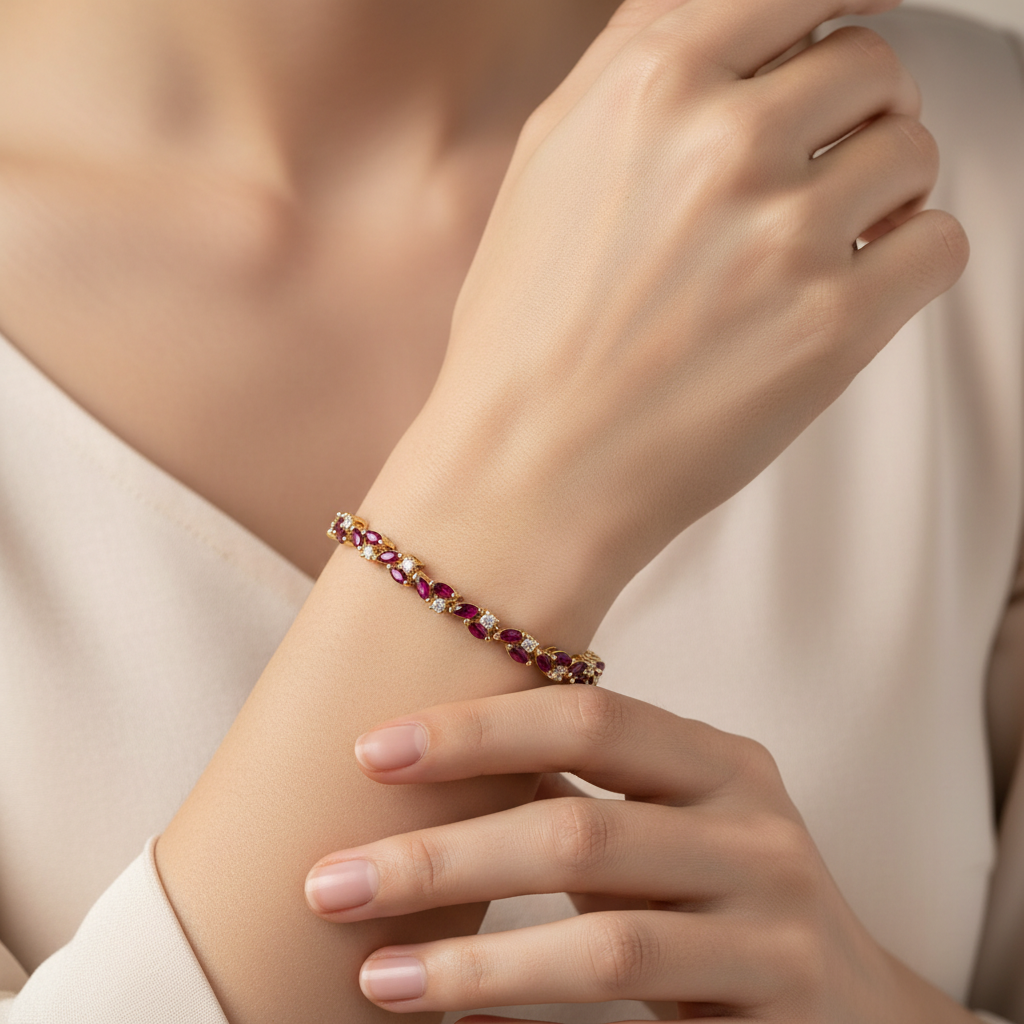 Lifestyle image of gold brass bracelet with ruby red synthetic garnet stones on wrist
